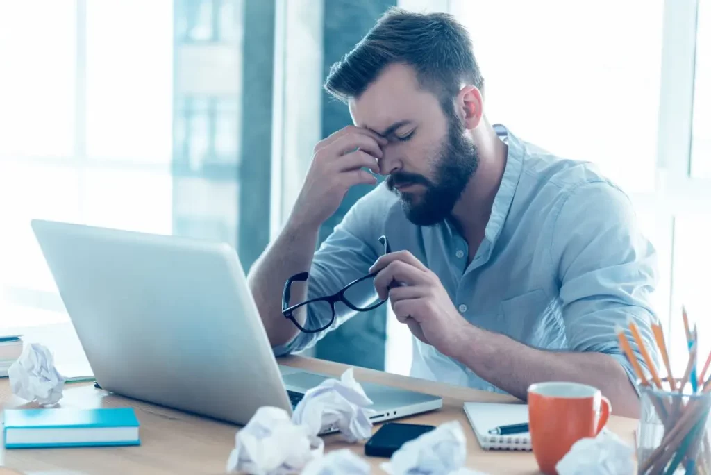 a tired man at a laptop considering TRT