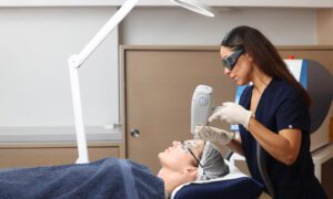 image of patient having fractional laser treatment with skin specialist at Omniya Clinic