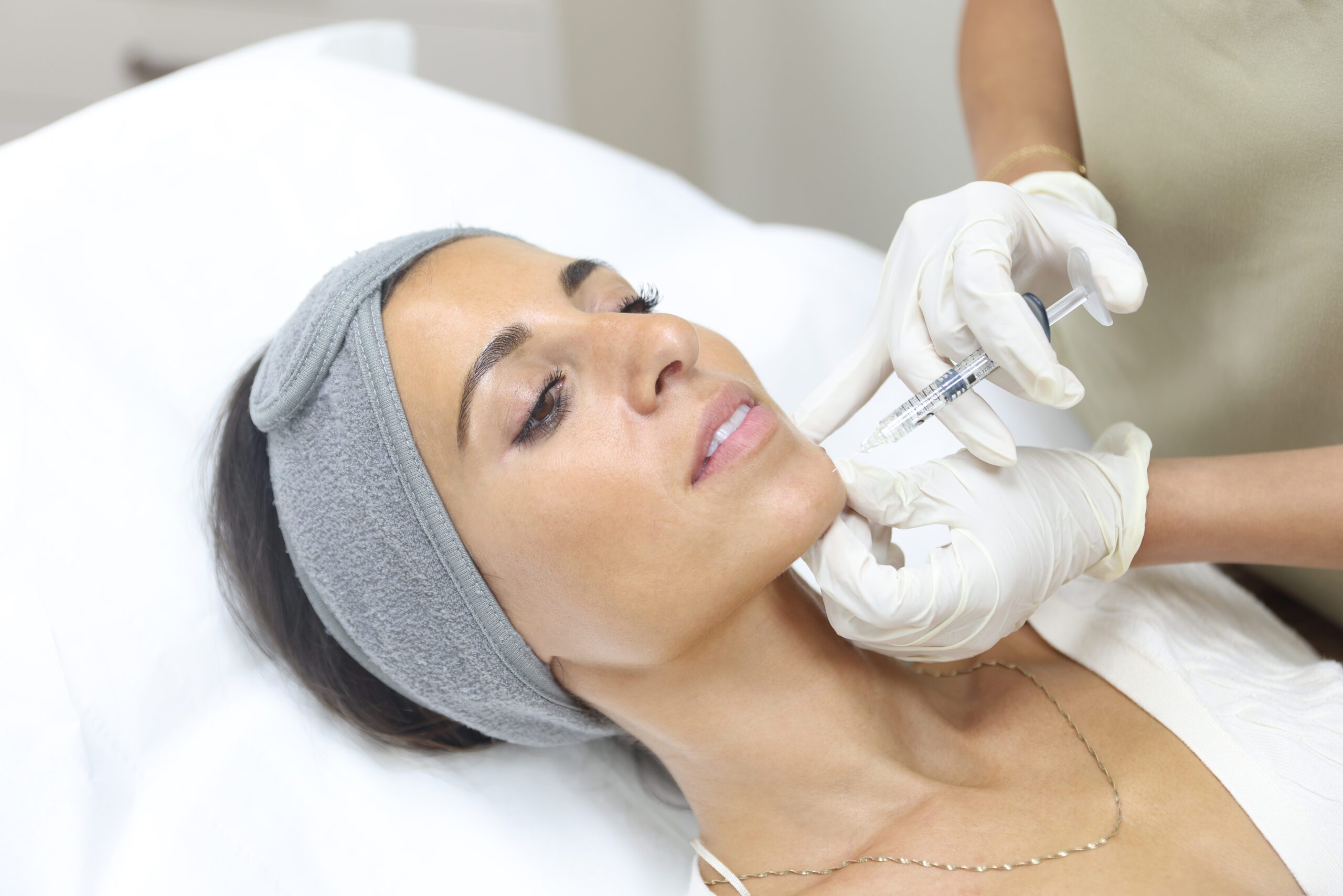 patient having chin dermal filler at Omniya Clinic